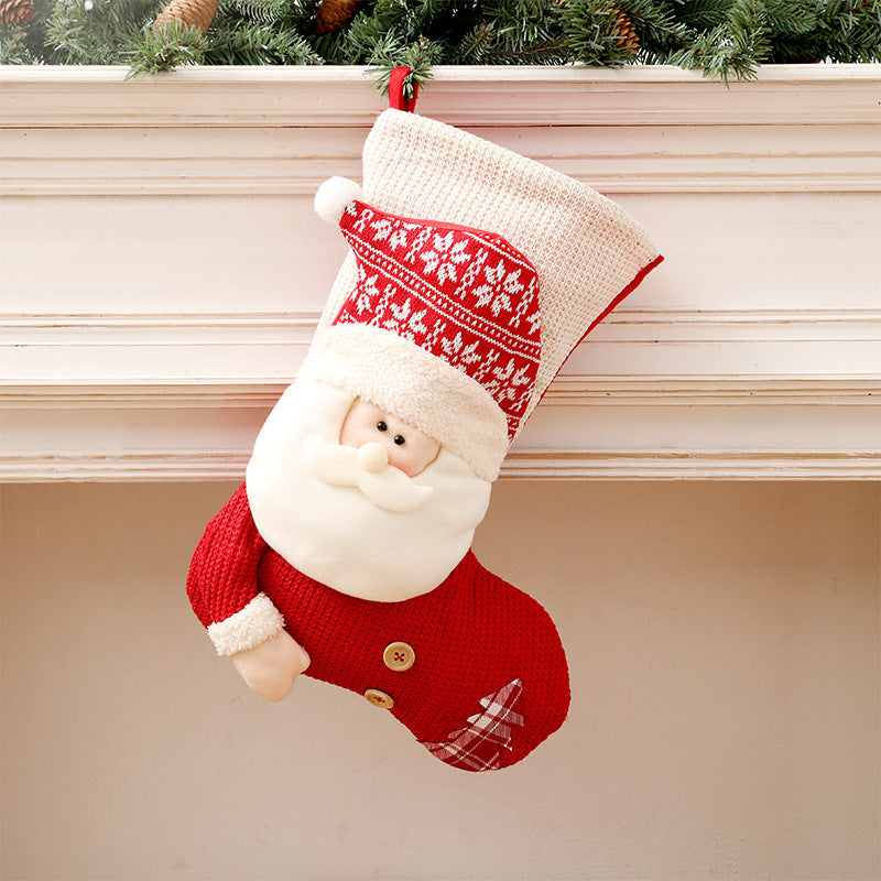 Gebreide kerstsok met kerstman of sneeuwpop