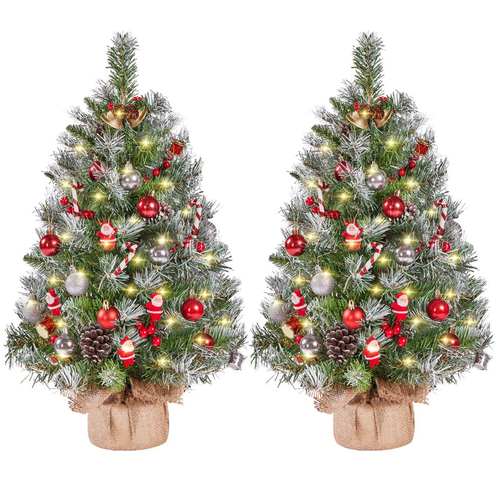 Twee berijpte tafelkerstbomen met lichtjes