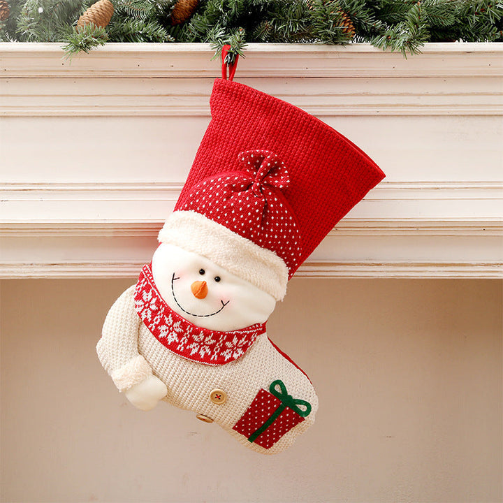 Gebreide kerstsok met kerstman of sneeuwpop