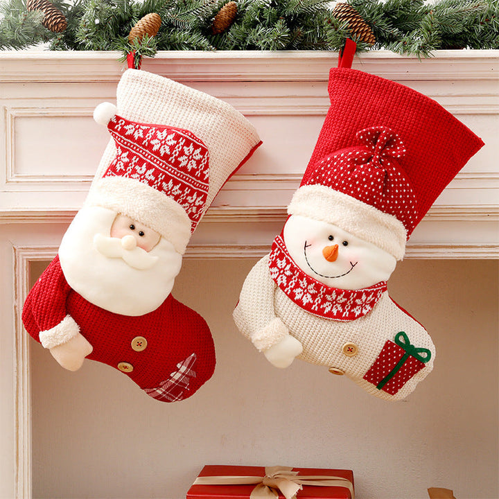 Gebreide kerstsok met kerstman of sneeuwpop