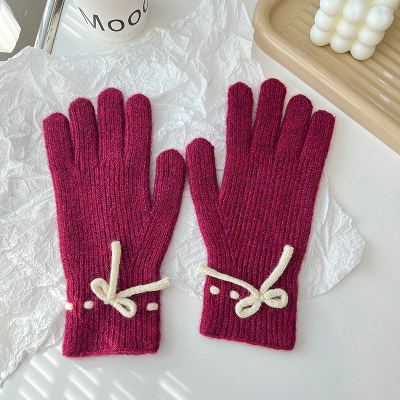 Geribde handschoenen met strikje bij de pols