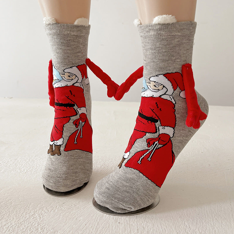 Twee kerstsokken met magnetische handjes