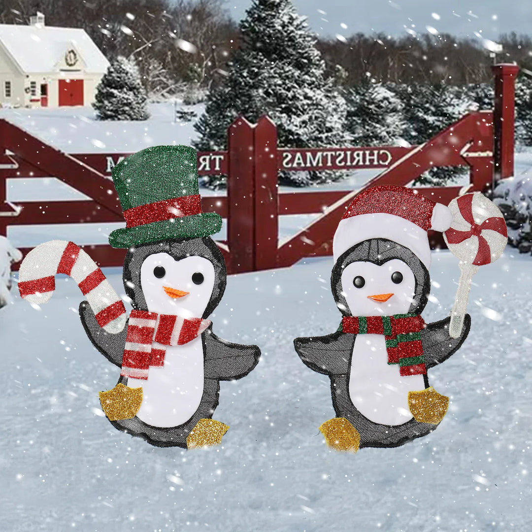 Twee verlichte pinguïns met zuurstok