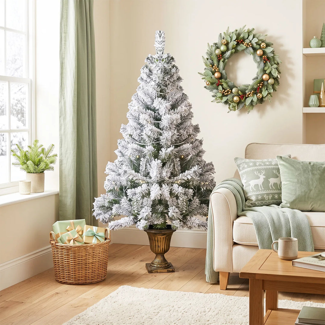Kleine besneeuwde kerstboom in pot