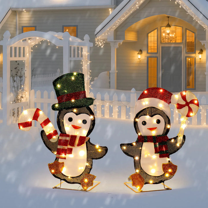 Twee verlichte pinguïns met zuurstok
