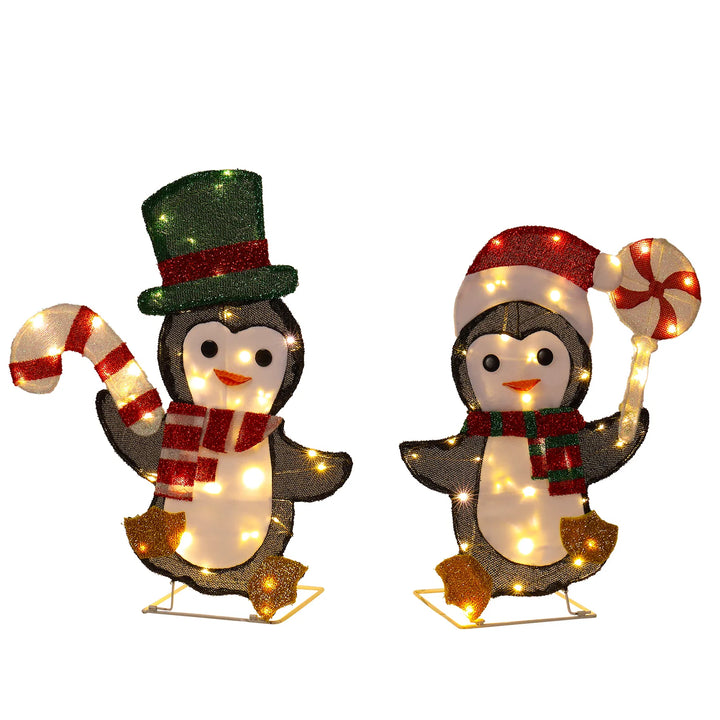 Twee verlichte pinguïns met zuurstok