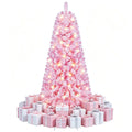 Kleine roze besneeuwde kerstboom met lichtjes