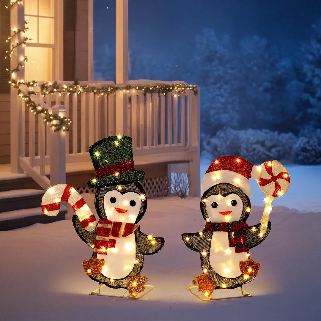 Twee verlichte pinguïns met zuurstok