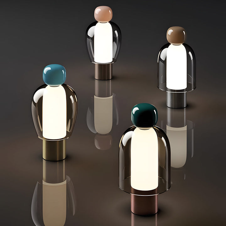 Draagbare glazen LED-tafellamp met figuursilhouet en metalen voet